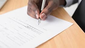 Hand signing a legal document