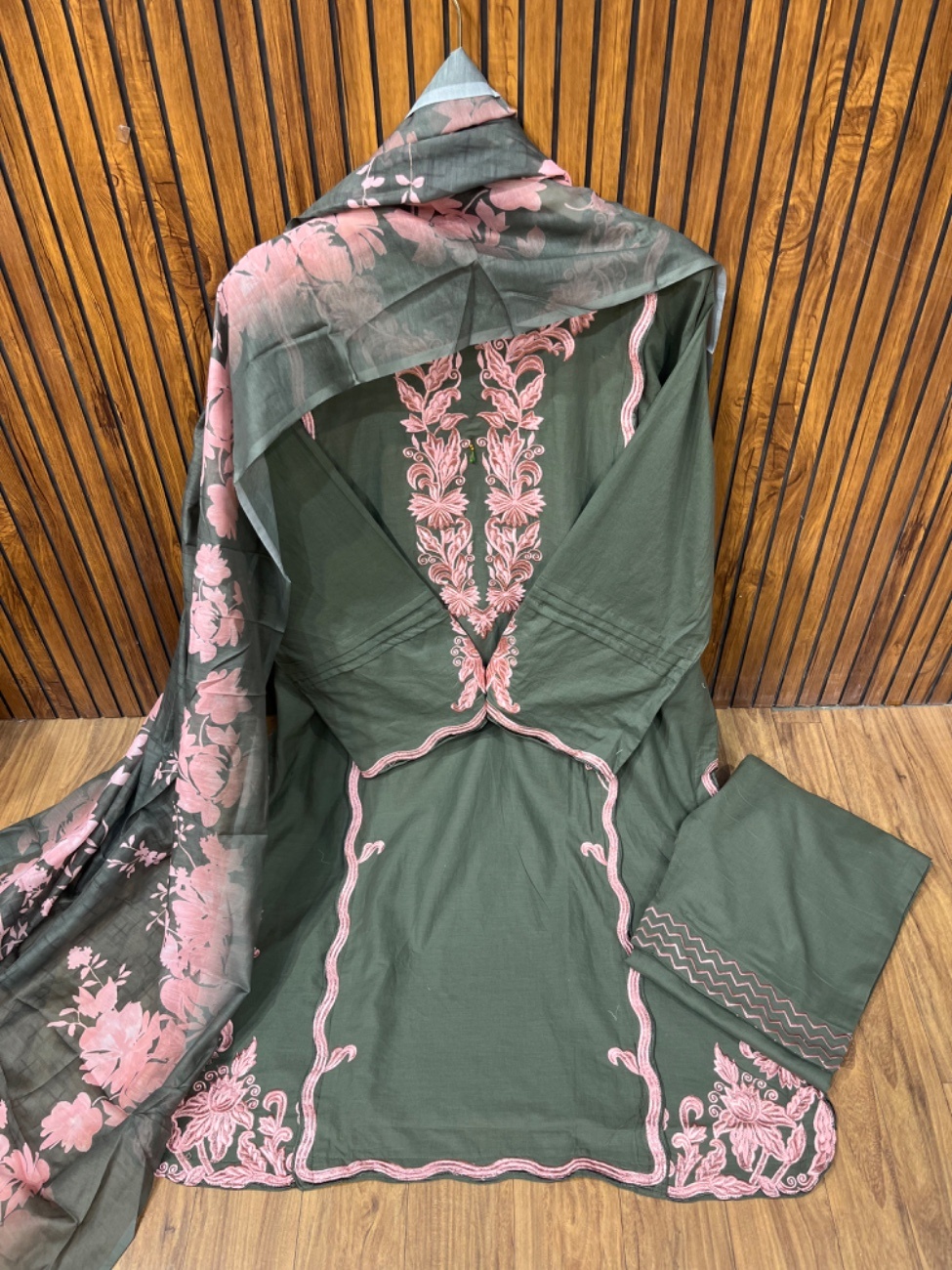 This stunning olive green pink suit features elegant black heavy embroidery