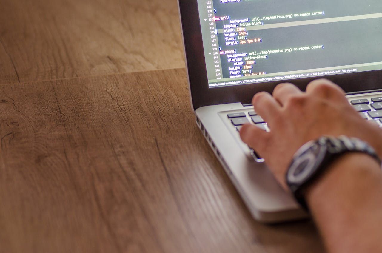 A close-up of someone building a website on a laptop using HTML code