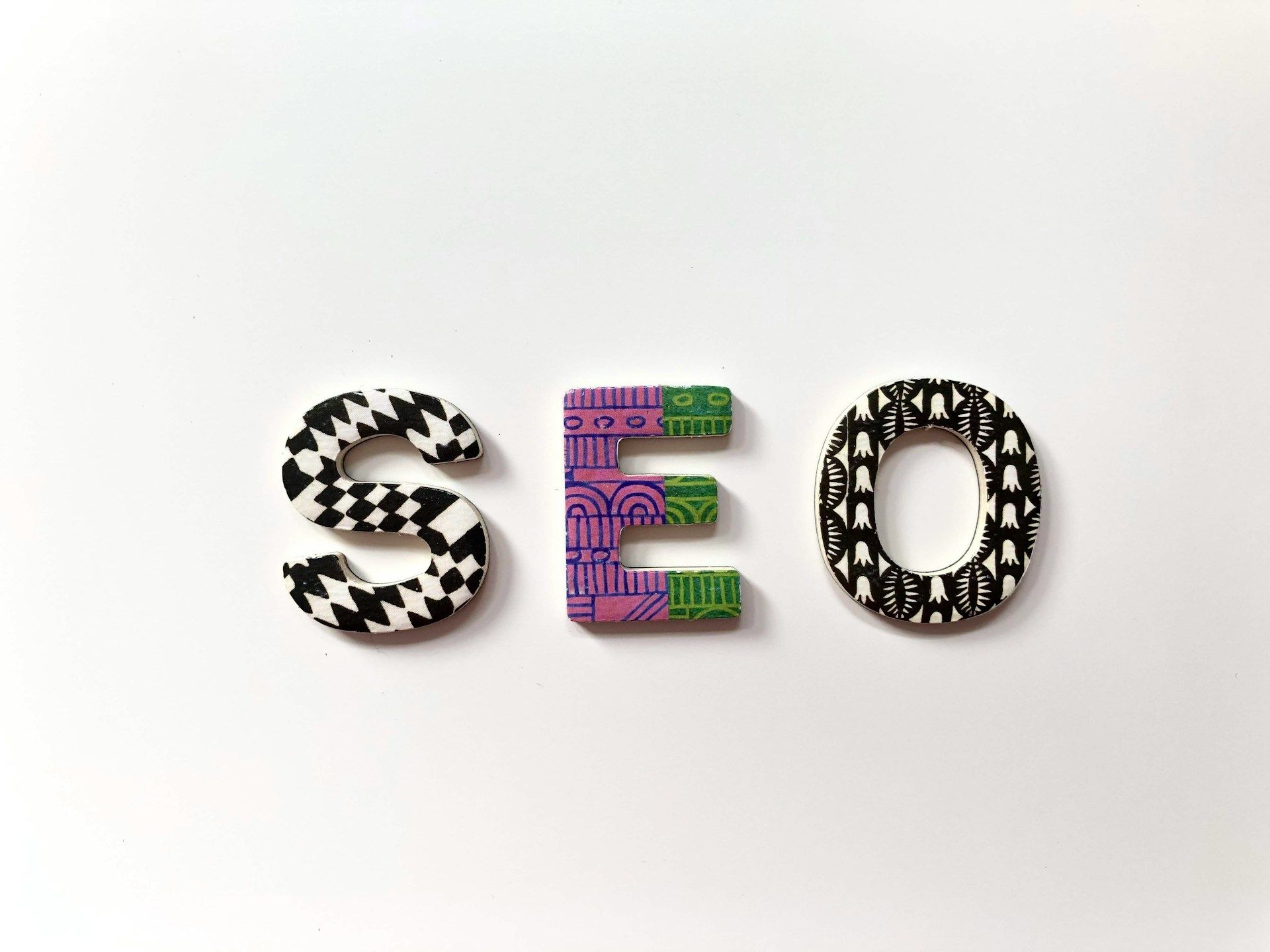 An illustrated graphic with three patterned letters that spell “SEO”