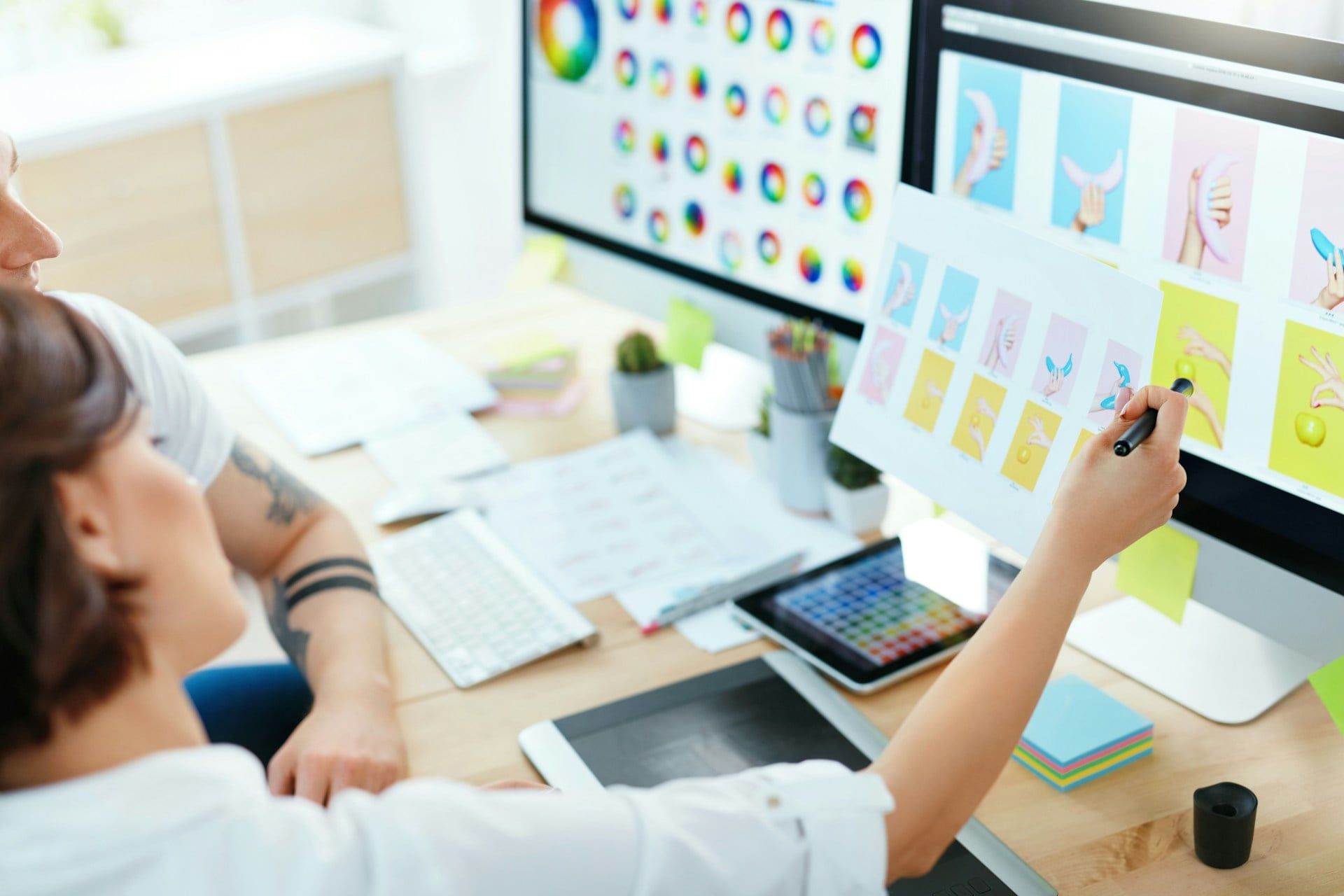 Two people working on a website’s colour scheme
