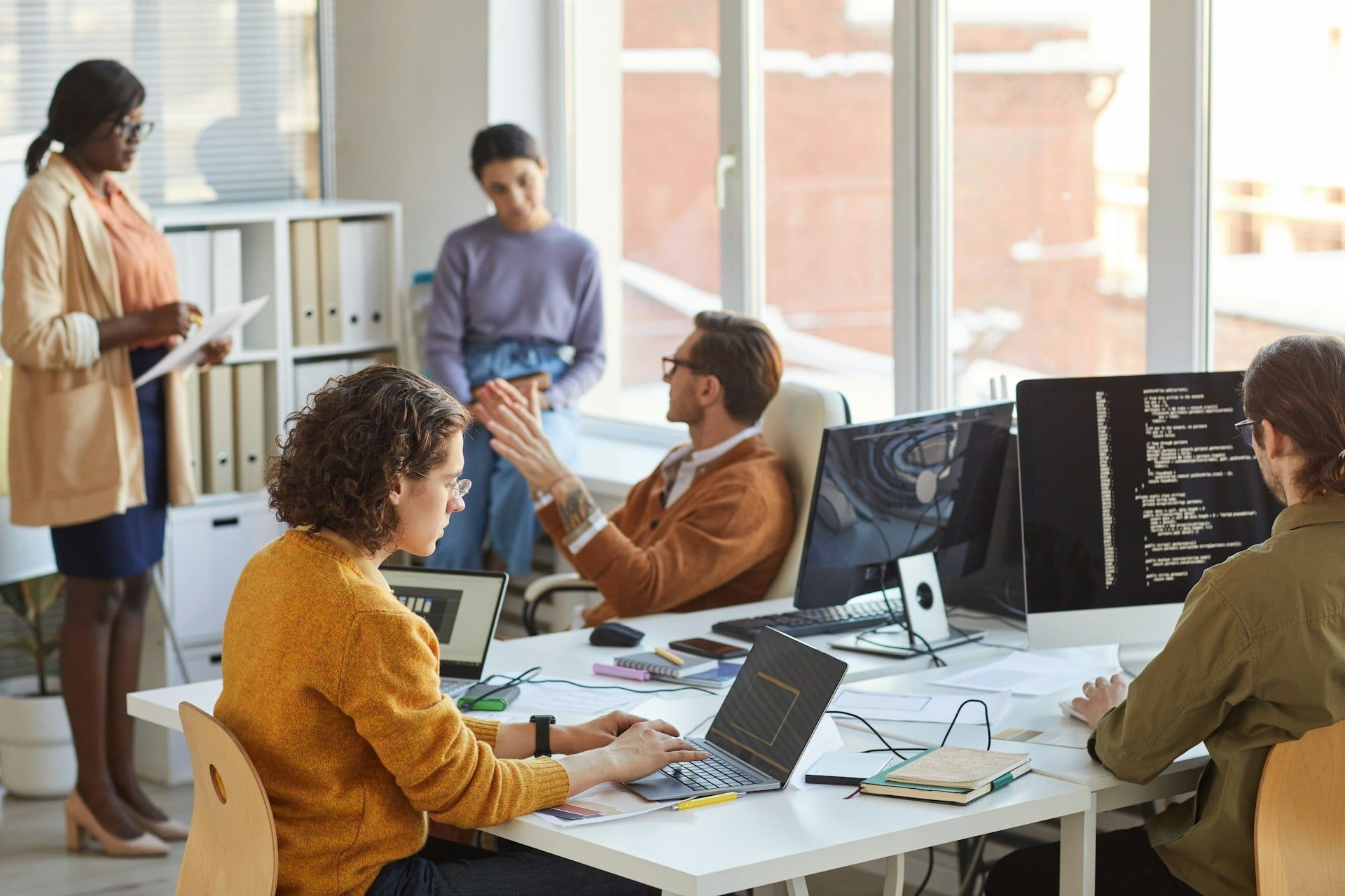 A group of website developers work on a project and chat