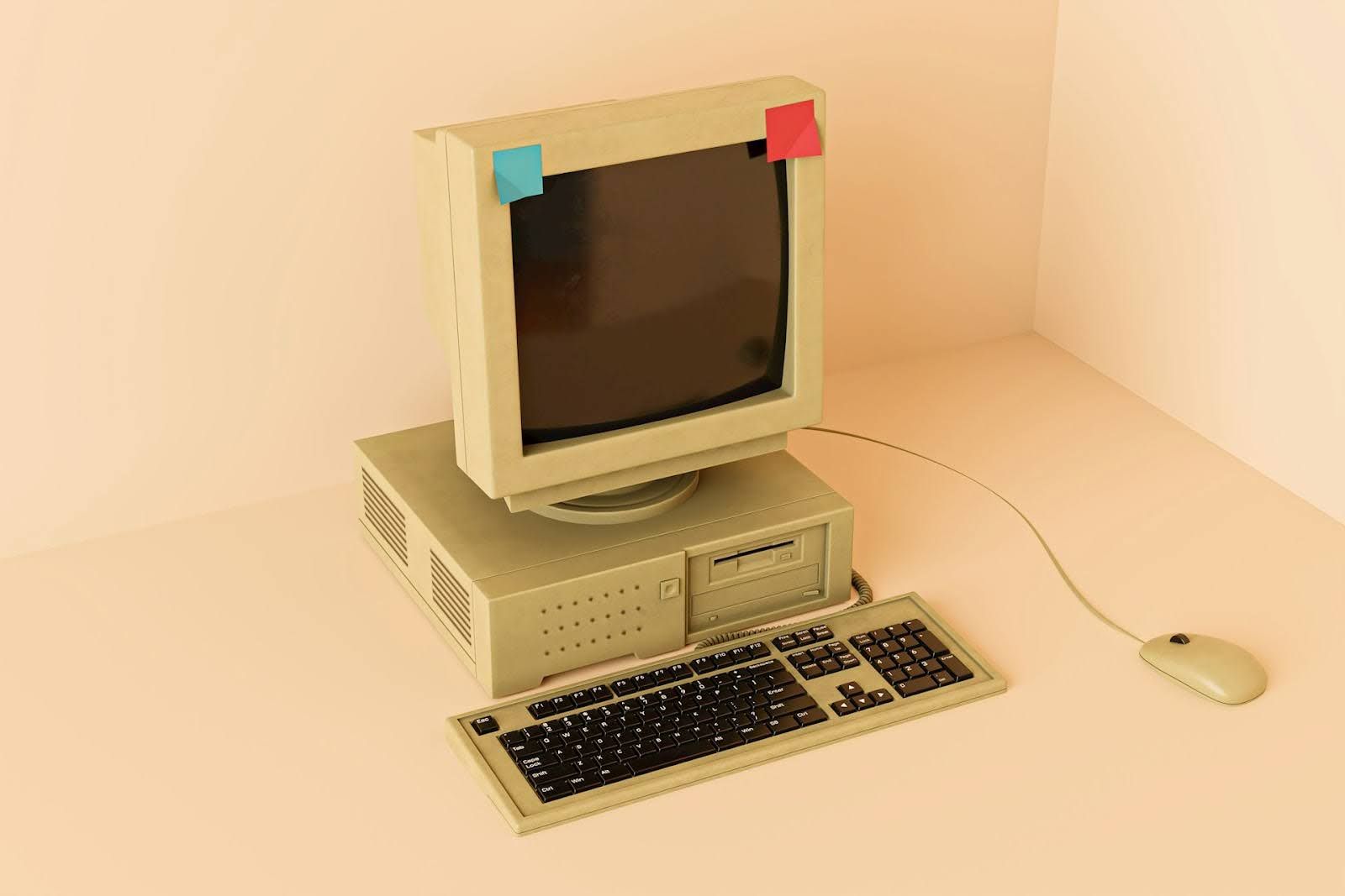 An old looking desktop computer with a large monitor and floppy disk drive