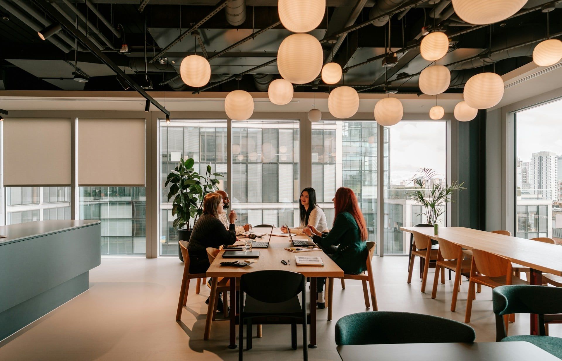 A startup team sit in a beautiful, aesthetic office discussing the plans for the future of their website