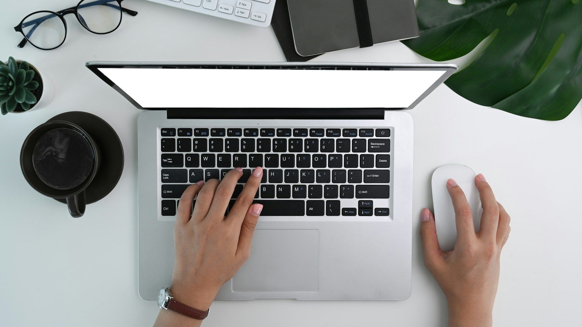 A top-down shot of someone using a laptop to optimize their local SEO
