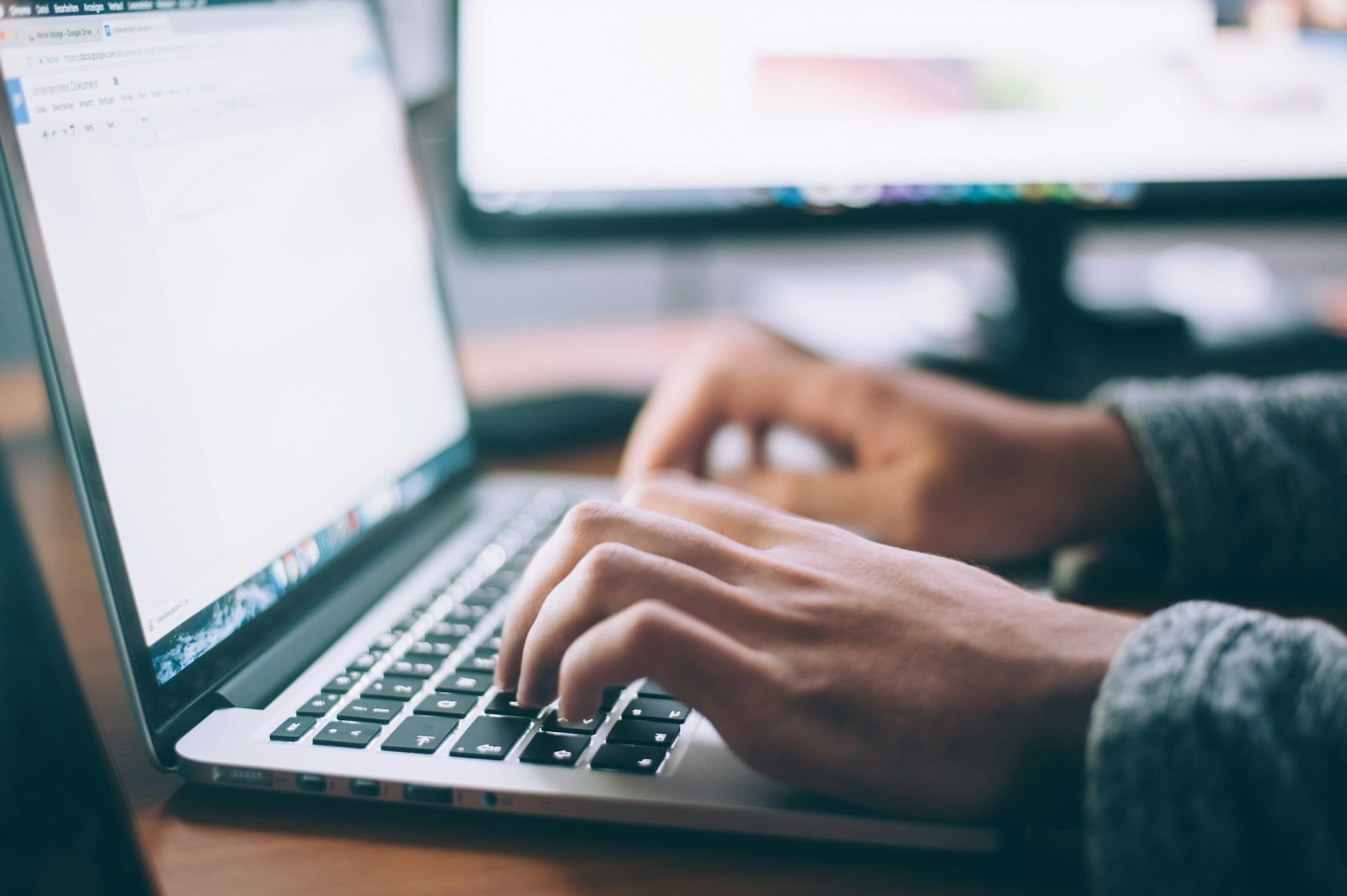 A close-up of someone using a laptop on Google Docs to write their next blog post
