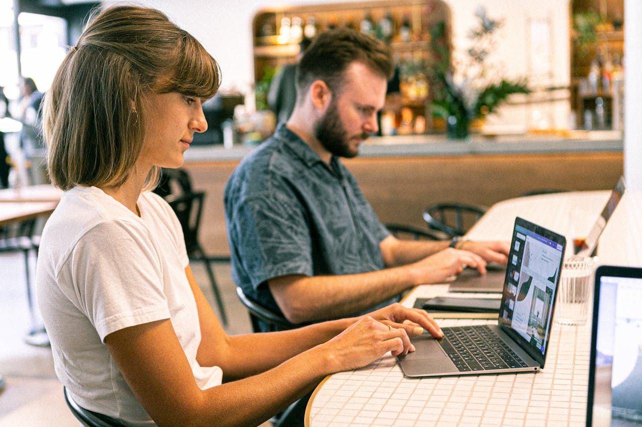 Two business partners sit and work on rebuilding their business’s website