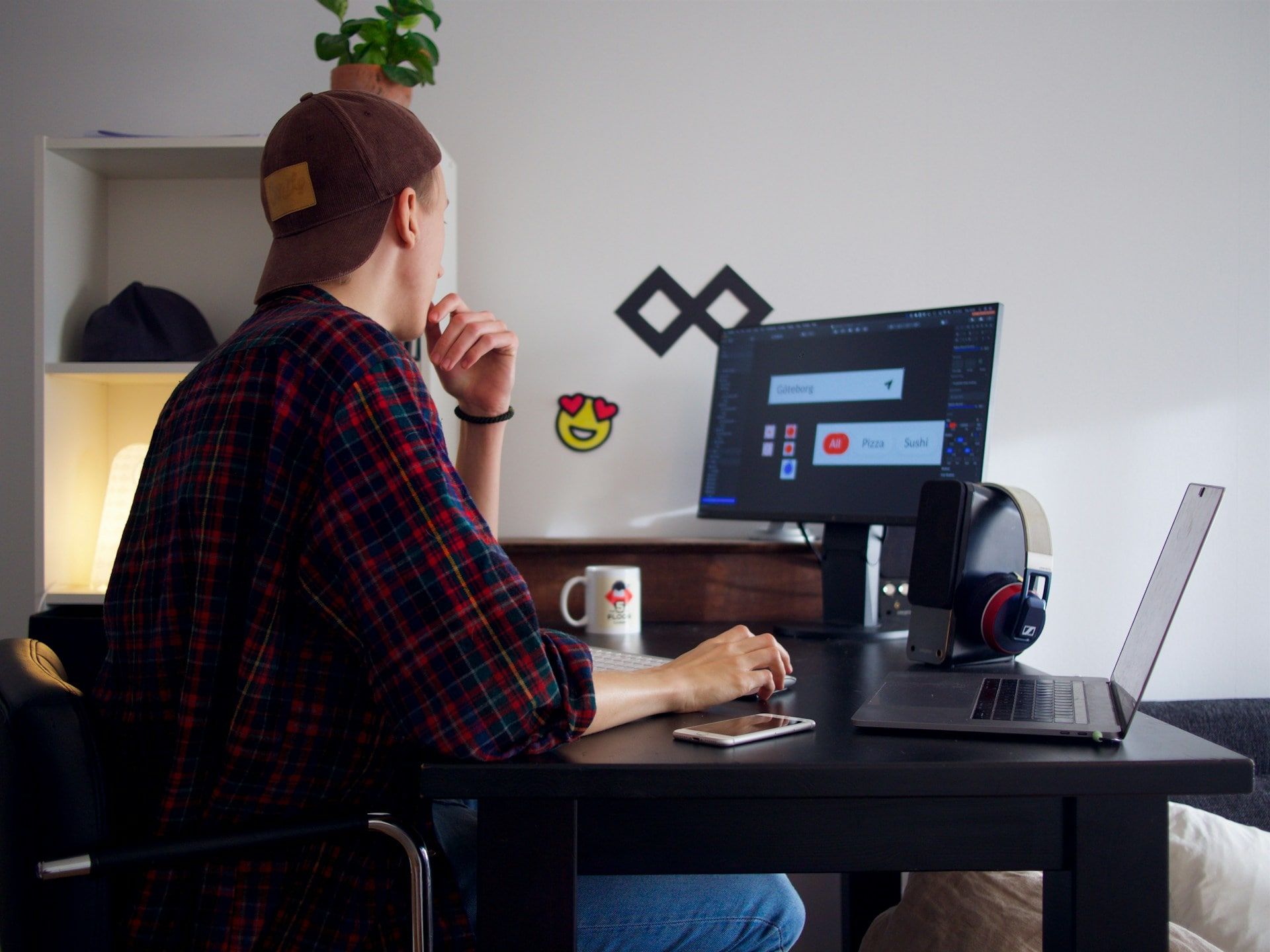  A graphic designer works at his desk creating visuals for his business