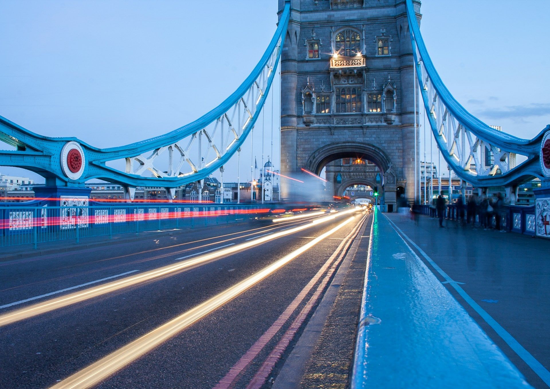  A bridge at dusk with light trails from cars travelling fast along it.