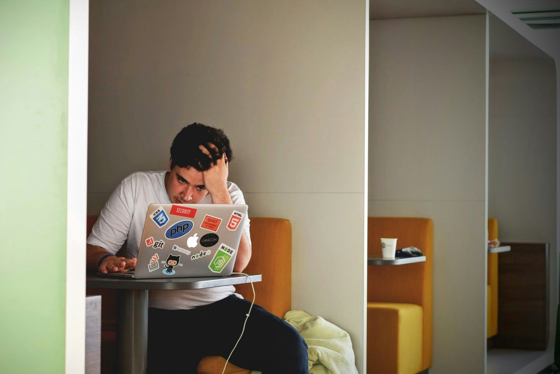 A man looking at his computer sadly and stressed due to the Google leak