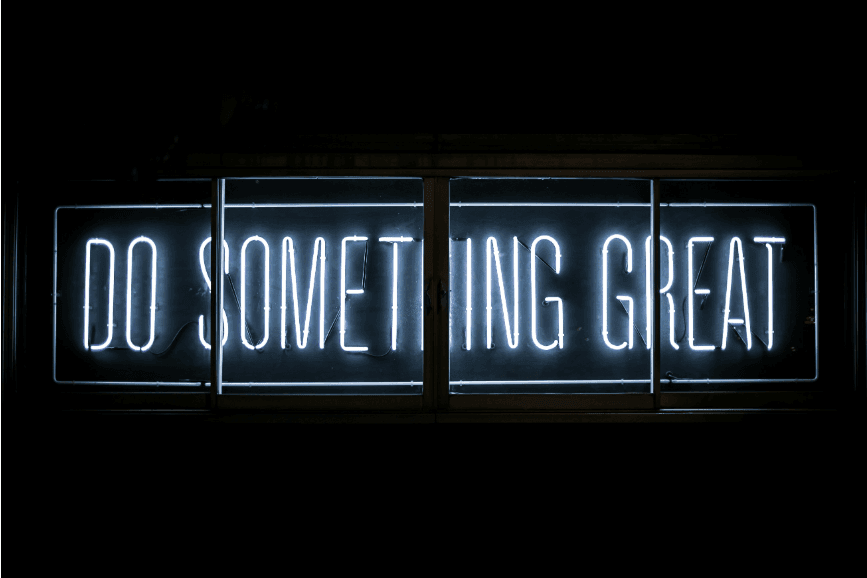 A vibrant neon sign glowing with the words 'Do Something Great,' radiating motivation and positivity.