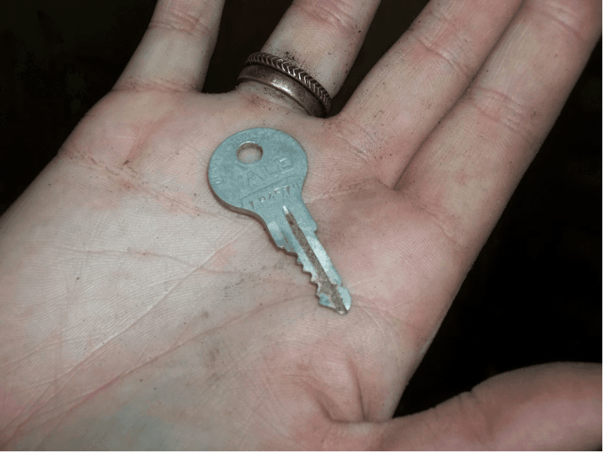 A hand holding a key.