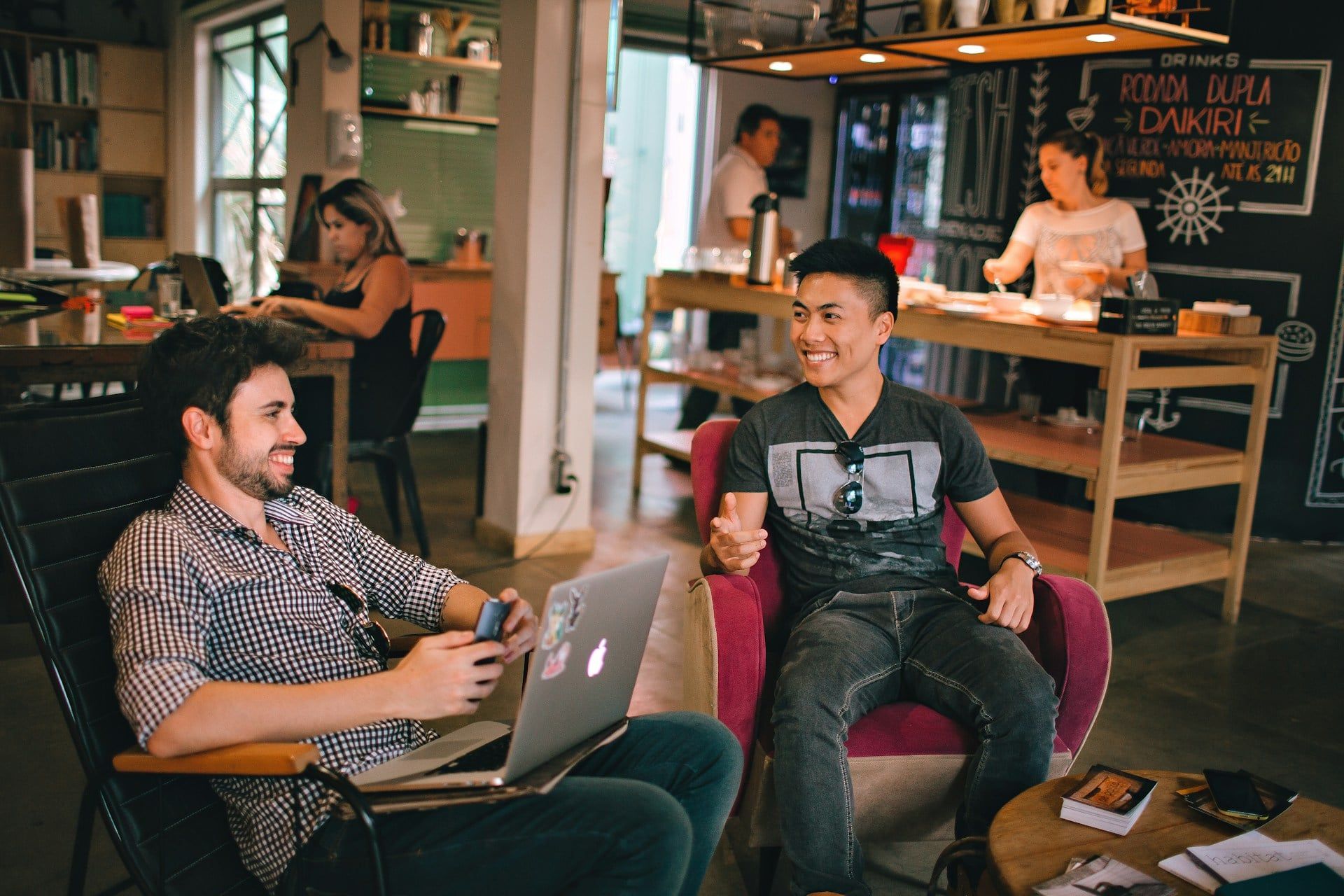 Two guys hanging out in a cafe networking