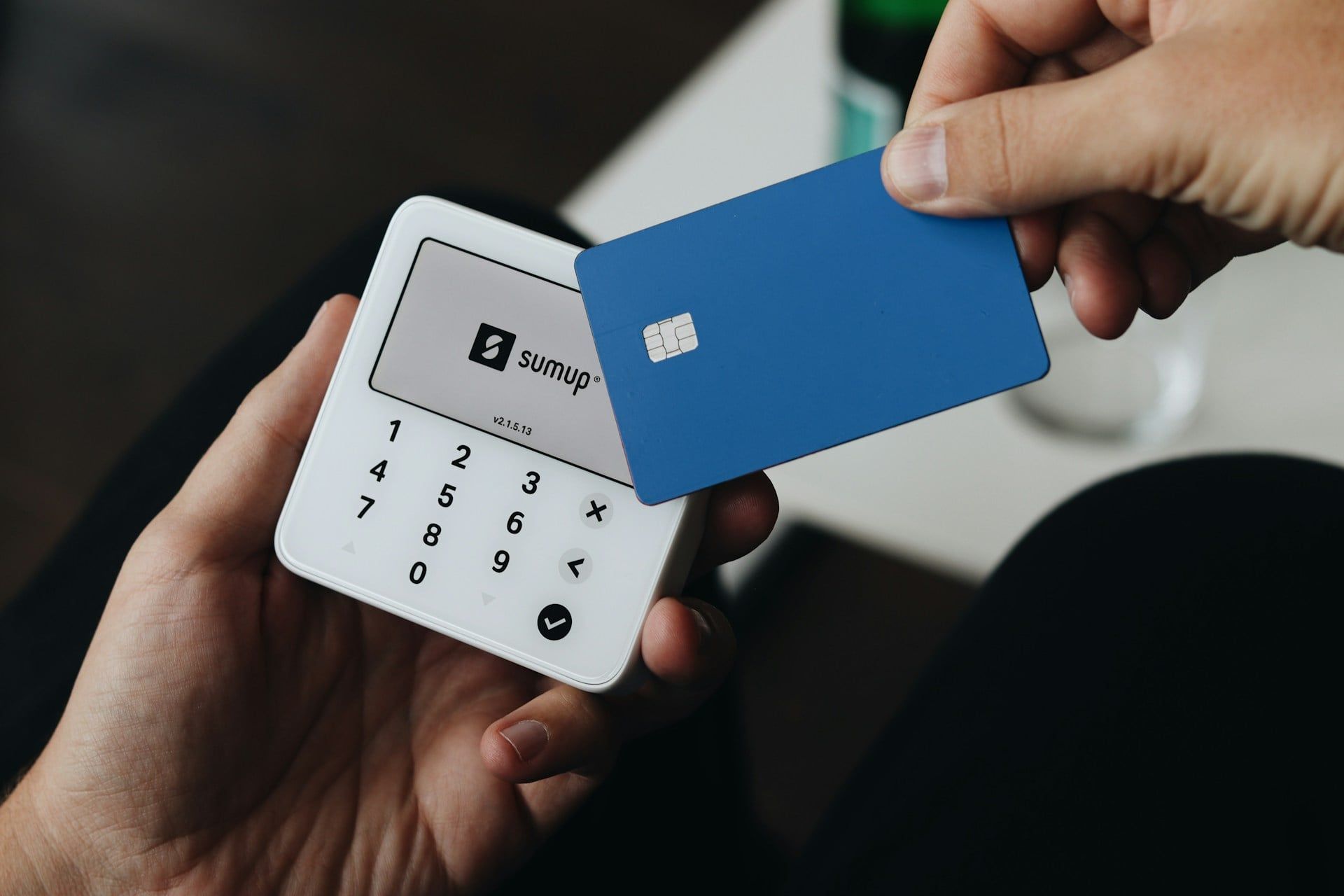 Someone paying by card using a Sum Up card reader