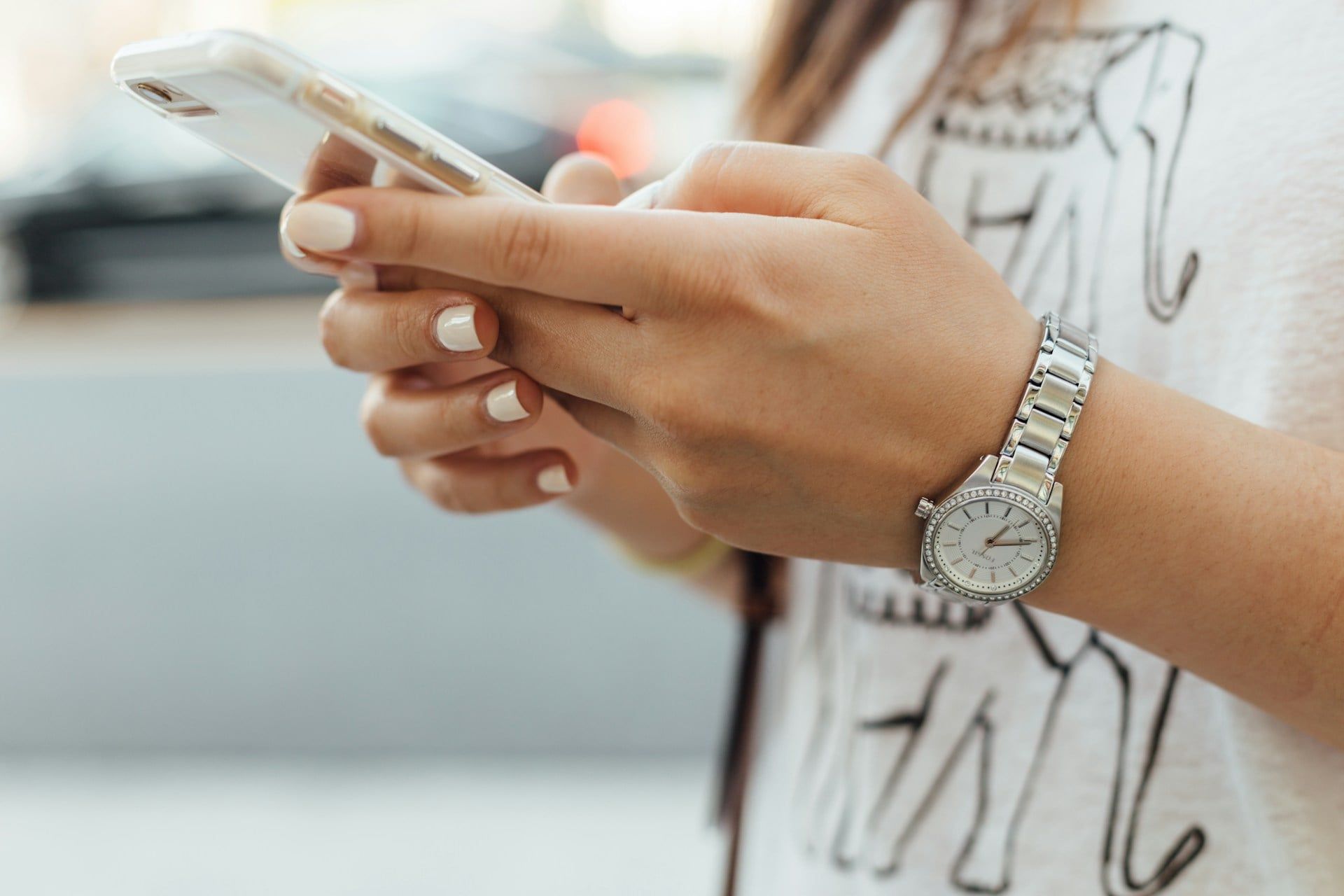 A close-up of a woman using her smartphone while out and about in Edmonton