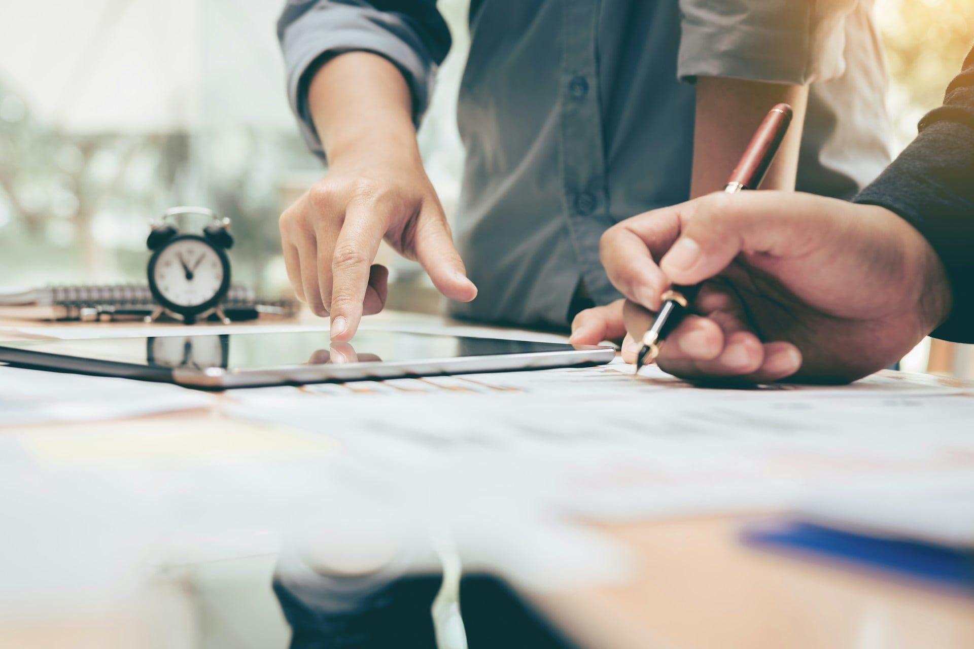 Two people conduct a content audit at a desk for their business