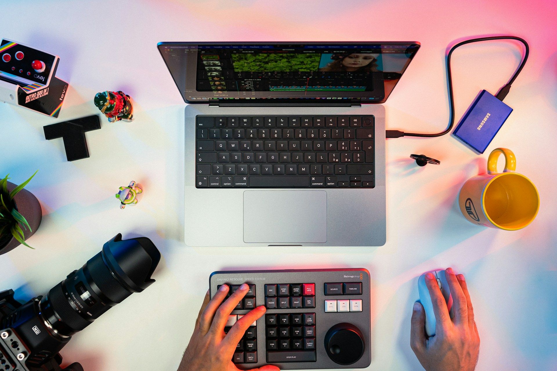 A top-down view of a desk with someone editing a video using tools and a computer