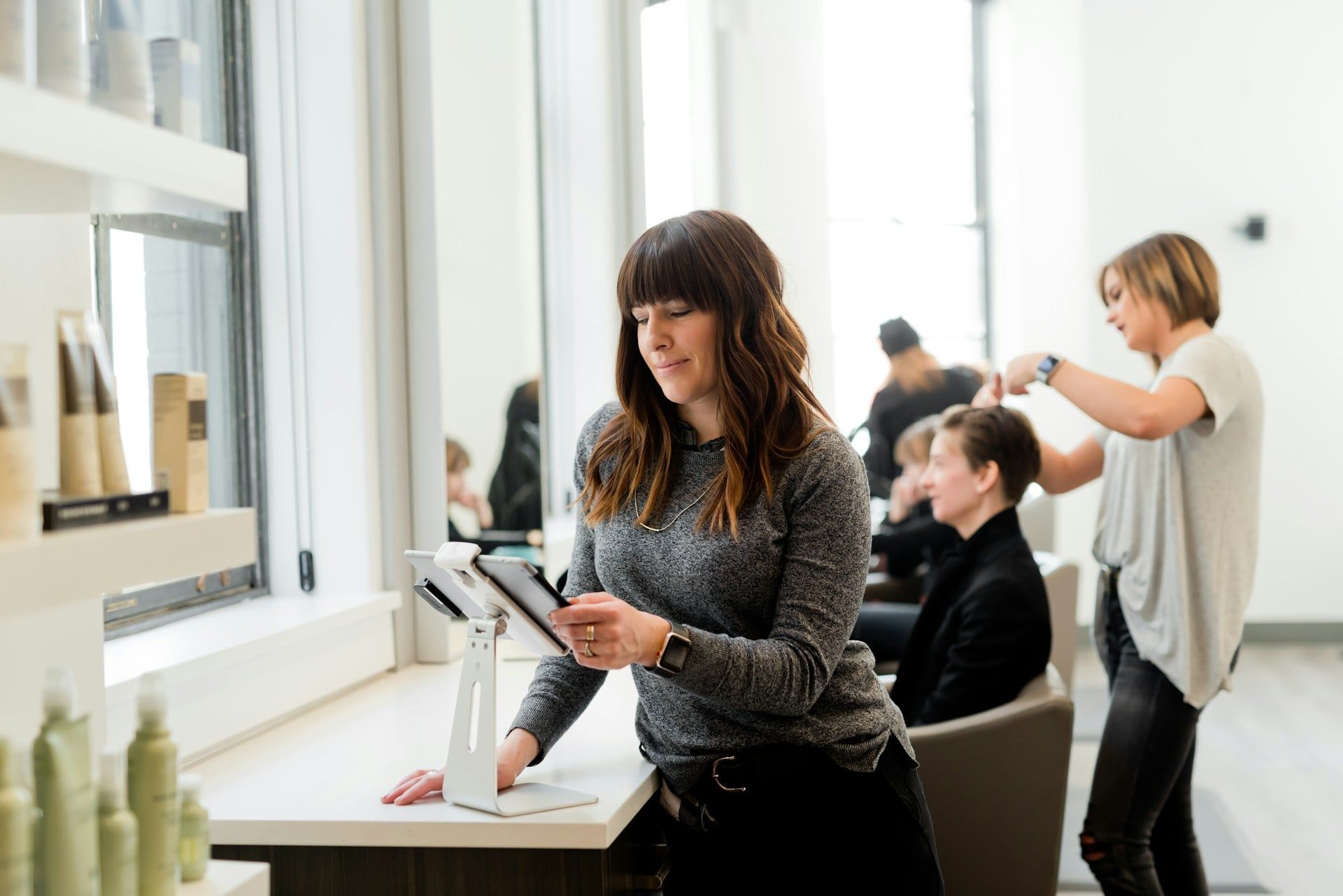 A female salon owner running her website from a tablet