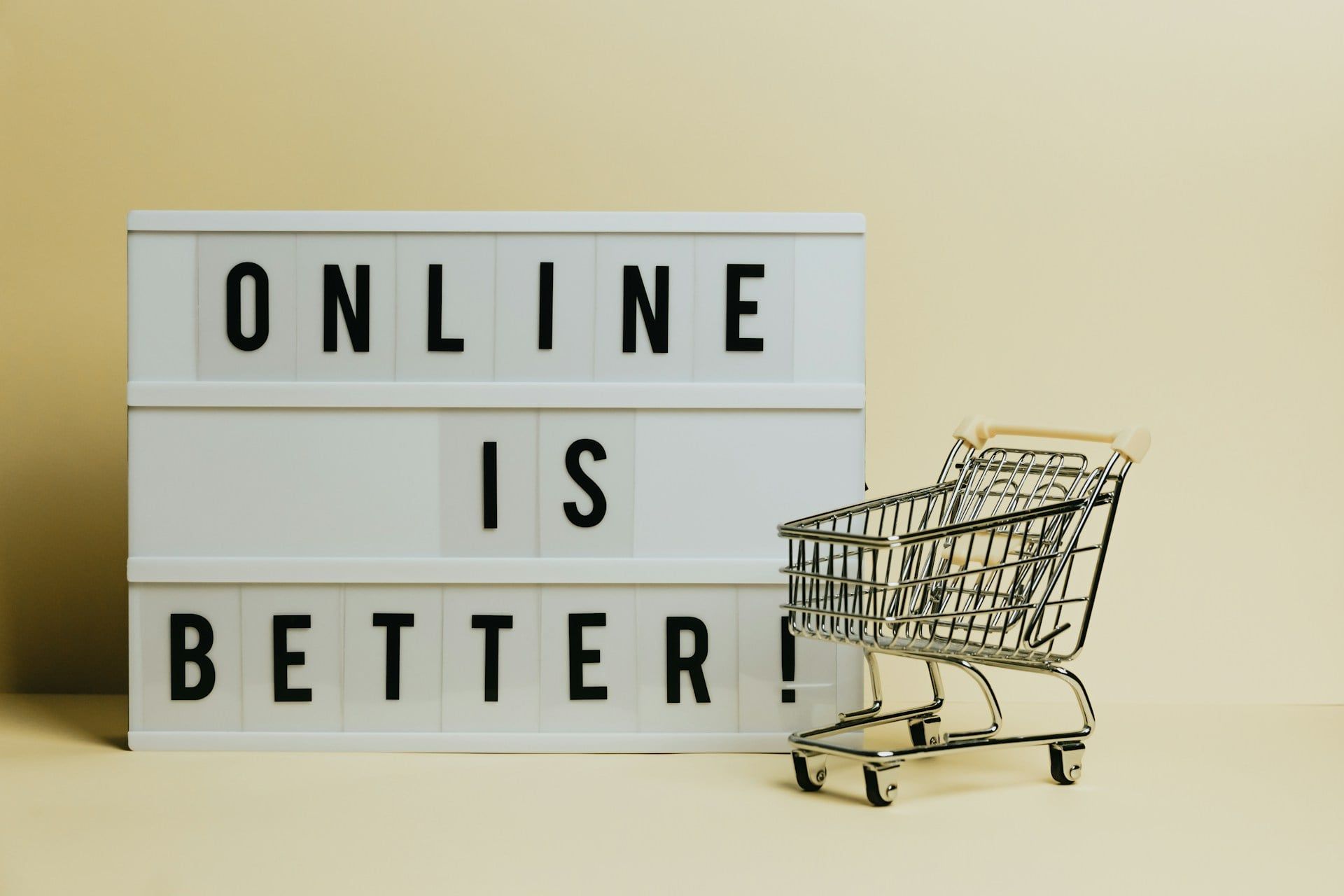 A sign that reads “online is better” with a little shopping cart model next to it