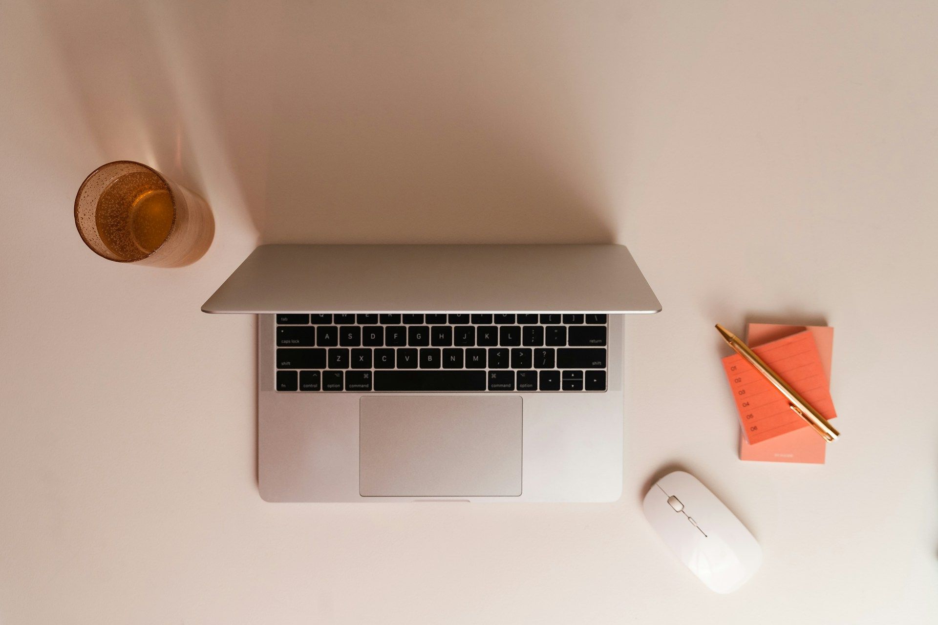 A top-down view of a desk with an open Macbook ready for writing blog posts
