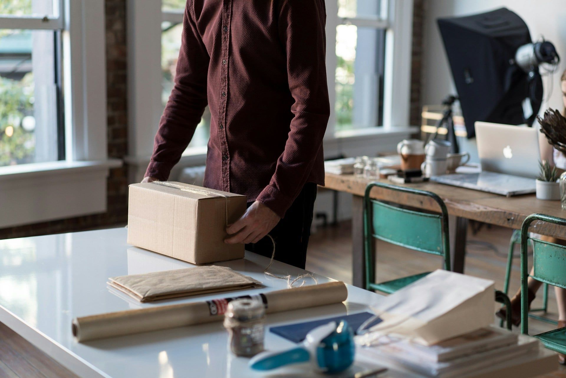 A small business owner wraps up an order ready to send to a customer