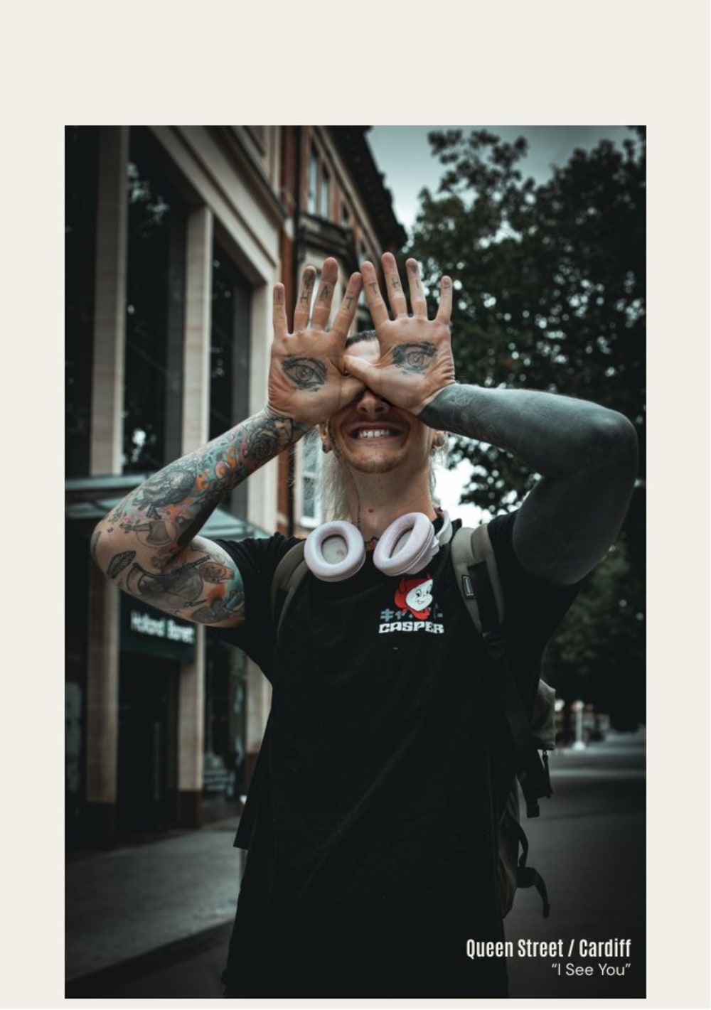 Portrait with tattooed hands held over the eyes
