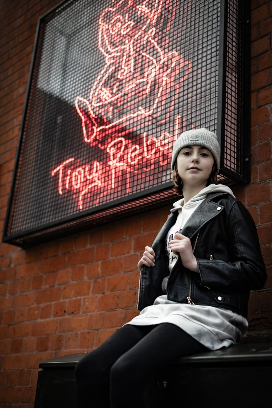 Location-based portrait of a young person in a leather jacket in Cardiff