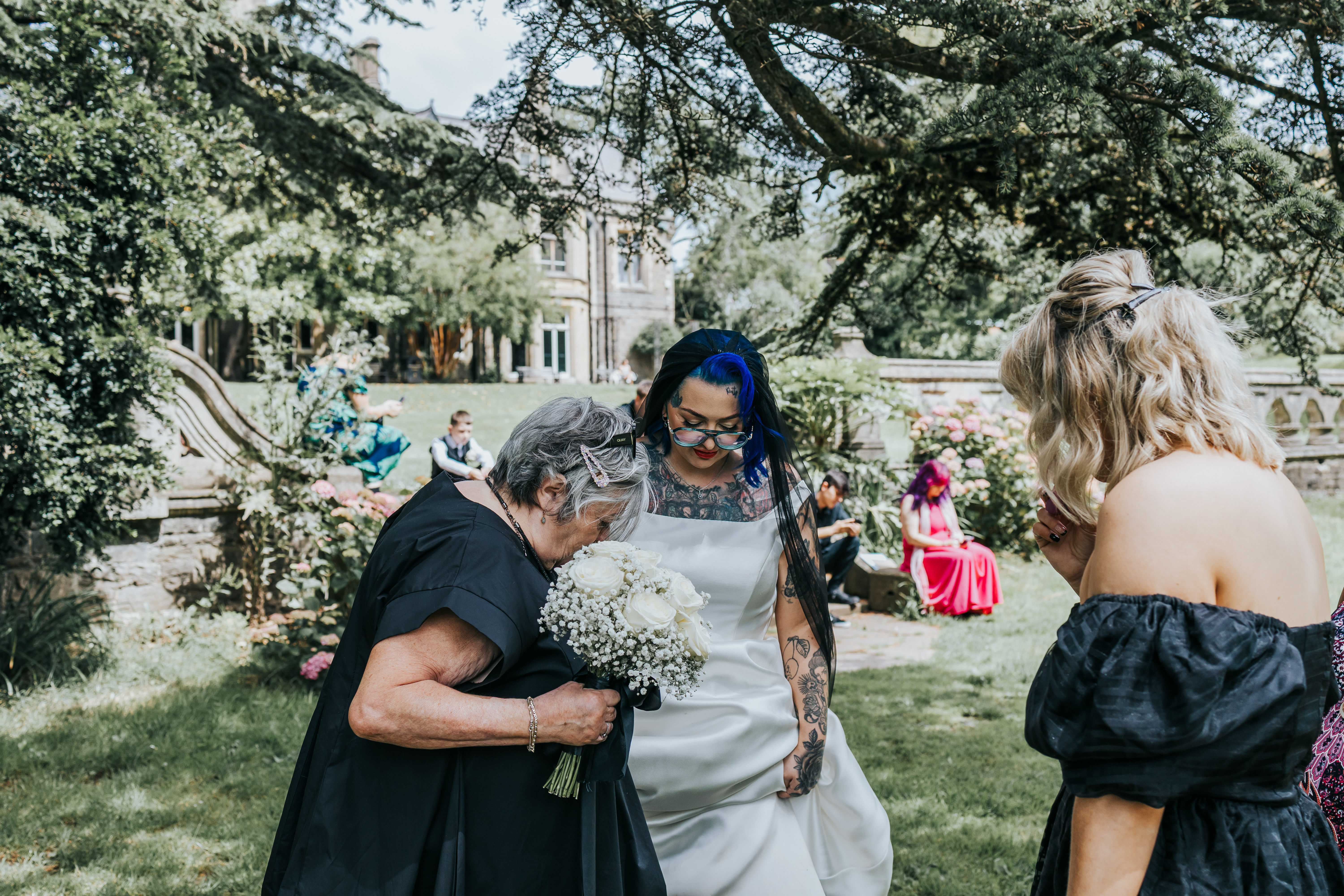 Bride enjoying an informal moment with guests in the garden