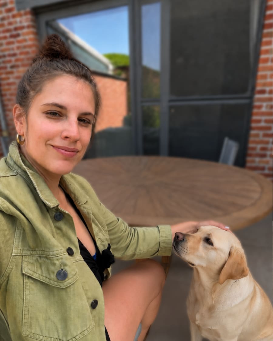 Magali De Reu on her terrace with her Labrador