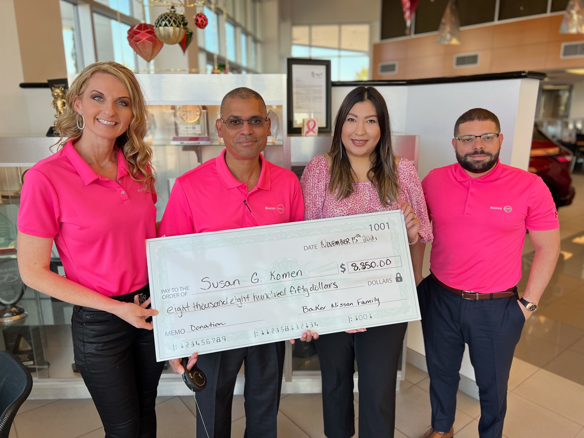 Baker Nissan Susan G. Komen donation presentation during Breast Cancer Awareness Month in Houston in 2021