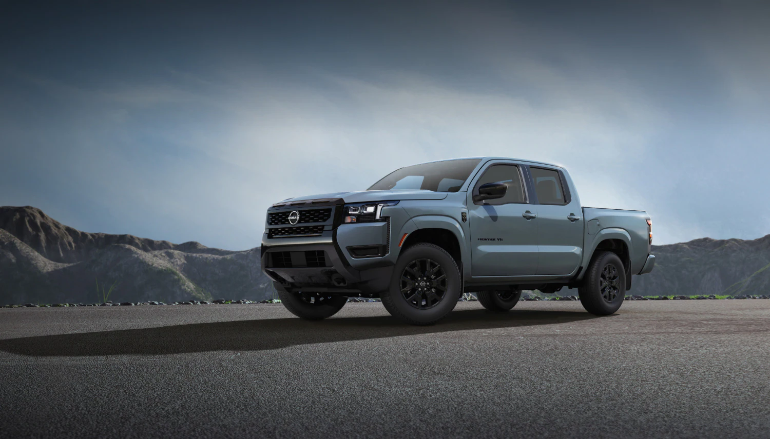 2027 Nissan Frontier Dark Armor pickup truck with black grille, black wheels and dark exterior accents