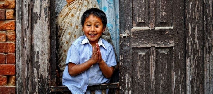 young cute nepali boy welcoming the guest
