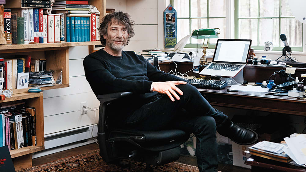 <strong>Neil Gaiman</strong> is a popular author who’s written books like <em>American Gods,</em> <em>Coraline</em>, and <em>The Ocean at the End of the Lane</em>. He’s revealed an internal rule that allows him to push through the resistance to writing: “You have permission to not write. You don’t have permission to do anything else.” (Photo Credit: <a href="https://variety.com/2019/tv/features/neil-gaiman-american-gods-good-omens-writers-office-interview-1203238915/">Variety</a>)