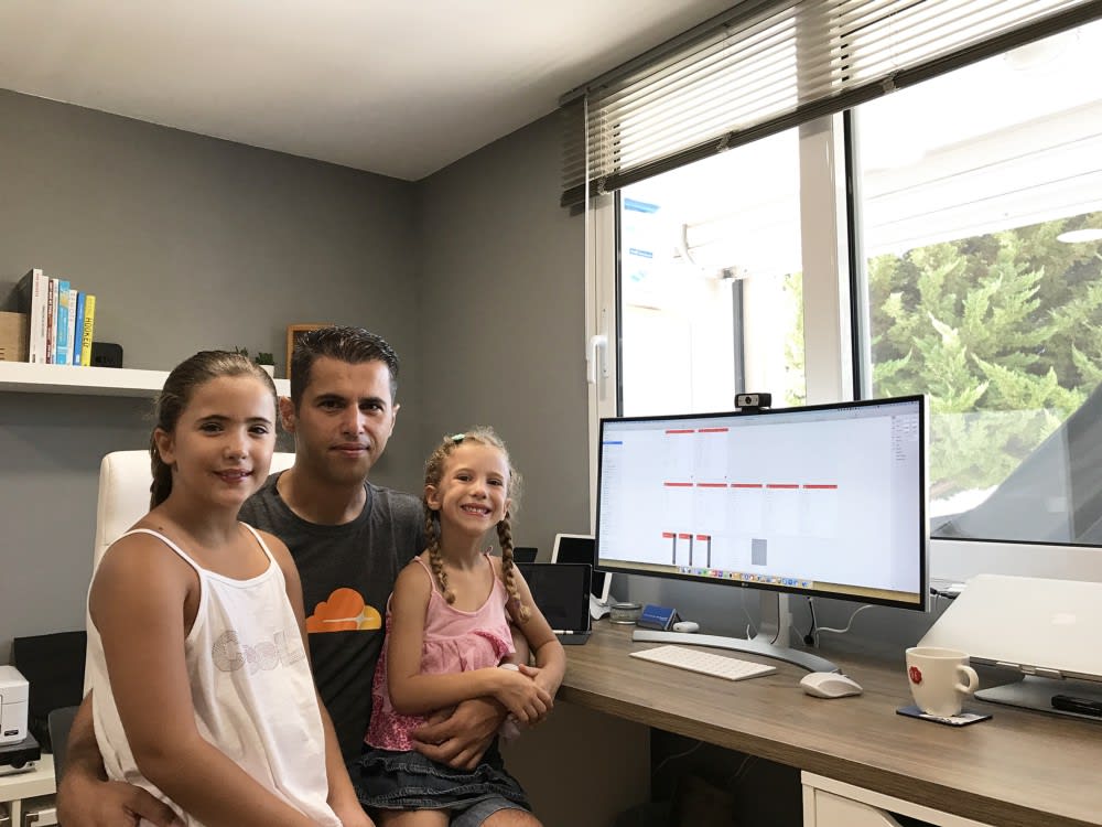 Panagiotis in his home office with his daughters, Stamatina & Elena