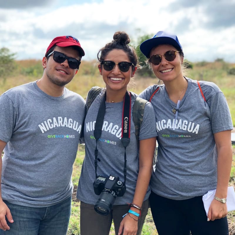 Caroline Pinal (middle) of Give Back Homes with colleagues, working at a site.