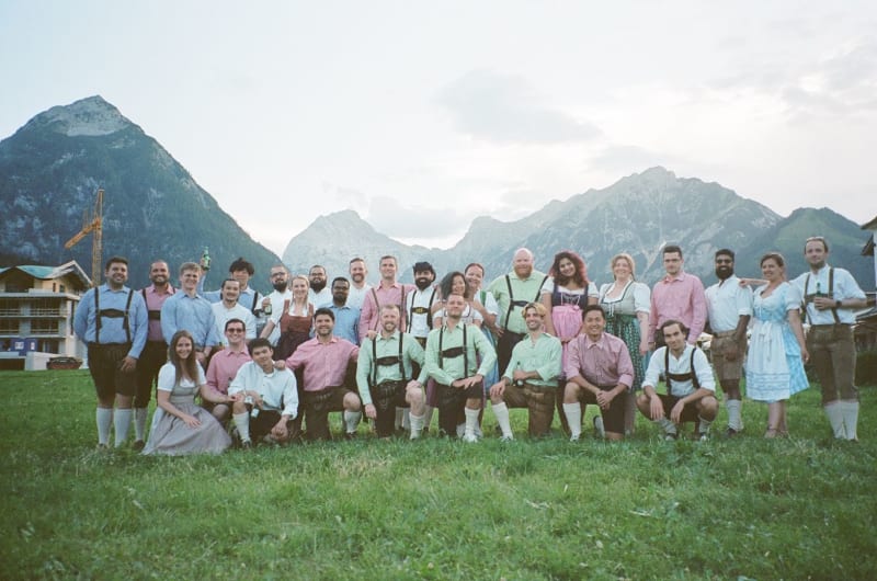 A photo of the Todoist team in traditional Austrian clothing, with gorgeous mountains in the background.