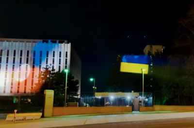 Protestors project Ukrainian flag on Russian Embassy