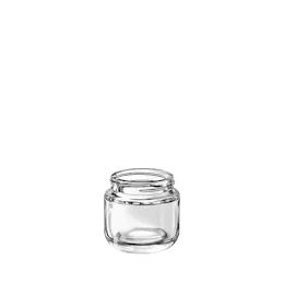 The image shows the Calaso 2.5oz Glass Jar (HM14011-100). It is a small, clear glass jar with a smooth, cylindrical shape. The jar has a wide mouth with threading for a screw-on lid, which is not shown in the image. The glass is transparent, allowing the contents to be visible, and the overall design is sleek and simple. The jar is empty and stands upright, showcasing its compact size and clean lines.