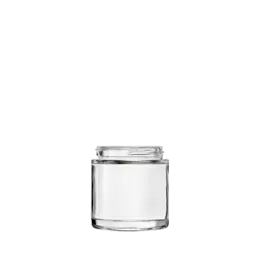 The image depicts the Calaso 3.4oz Glass Jar. The jar has a clear, cylindrical body with smooth, straight sides and a wide-mouth opening. The glass appears thick and high-quality, and the jar is empty with no lid visible in the image. The base of the jar is slightly thicker, providing stability when placed on a surface. The overall design is simple and elegant, suitable for storing various contents.