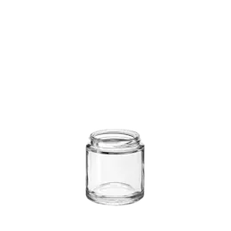 The image shows the Calaso 3.4oz Glass Jar HD13095-100. The jar is transparent and cylindrical with a smooth, seamless surface. It has a wide mouth, which is suitable for easy filling and access. The jar sits on a flat base, providing stability. The glass appears thick and durable, suitable for containing various substances securely.
