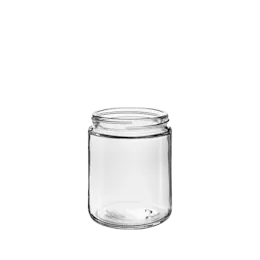 The image showcases the Calaso 8.5oz Glass Jar by Glasmeister. The jar is cylindrical with a clear, smooth glass surface, allowing visibility of its contents. It features a wide mouth opening, suitable for easy filling and dispensing. The jar is empty, and there is no lid visible in the image. The overall design is simple and elegant, making it versatile for various uses.