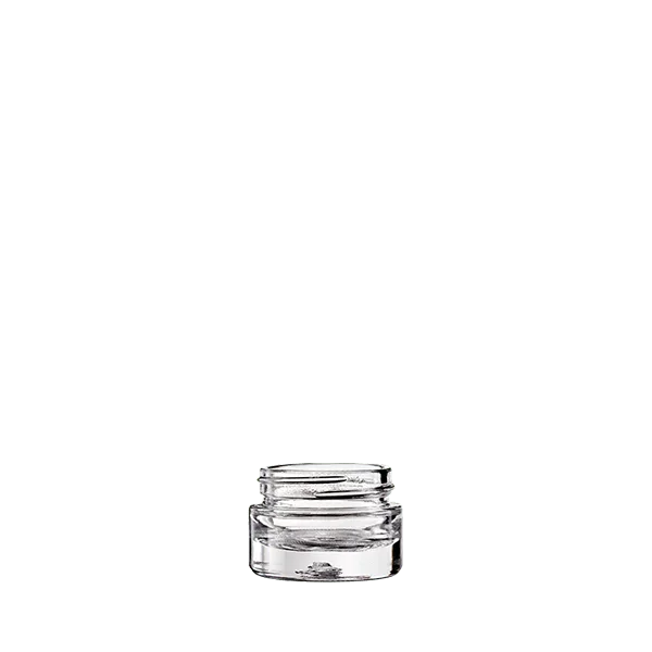 The image shows a clear, cylindrical glass jar with a smooth, seamless design. The jar has a wide opening and a flat base, making it suitable for various contents. This product is the Calaso 0.5oz Glass Jar. The clean lines and transparent nature of the glass highlight its simplicity and versatility.