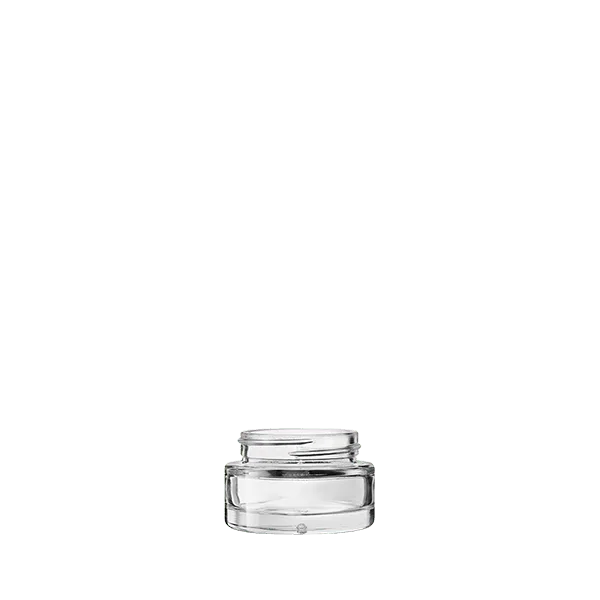 The image shows the Calaso 1.0oz Glass Jar. It is a small, cylindrical glass container with a clear, smooth surface. The jar has a wide mouth with a threaded neck designed to accommodate a screw-on lid, which is not shown in the image. The base of the jar is flat, allowing it to stand upright. The glass appears to be thick and sturdy, suitable for holding various contents.