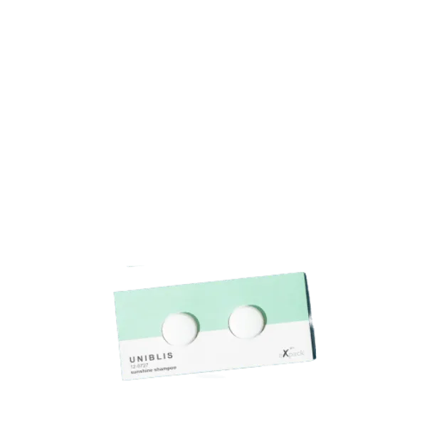 The image shows the Expack PP Standup Pouch - Tandem by Uniblis. The pouch is a flexible packaging solution with a transparent front that allows the contents to be visible. It has a resealable zipper at the top, enabling easy access and secure closure. The pouch stands upright on a flat base, making it convenient for display and storage. The design is clean and minimalistic, emphasizing functionality and visibility of the packaged product.