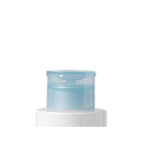 The image shows the Quadpack PP Pump, a sleek and modern dispensing pump designed for liquid products. The pump is primarily white with a cylindrical shape and a nozzle for dispensing. The design appears ergonomic, making it easy to use and suitable for various liquid containers.