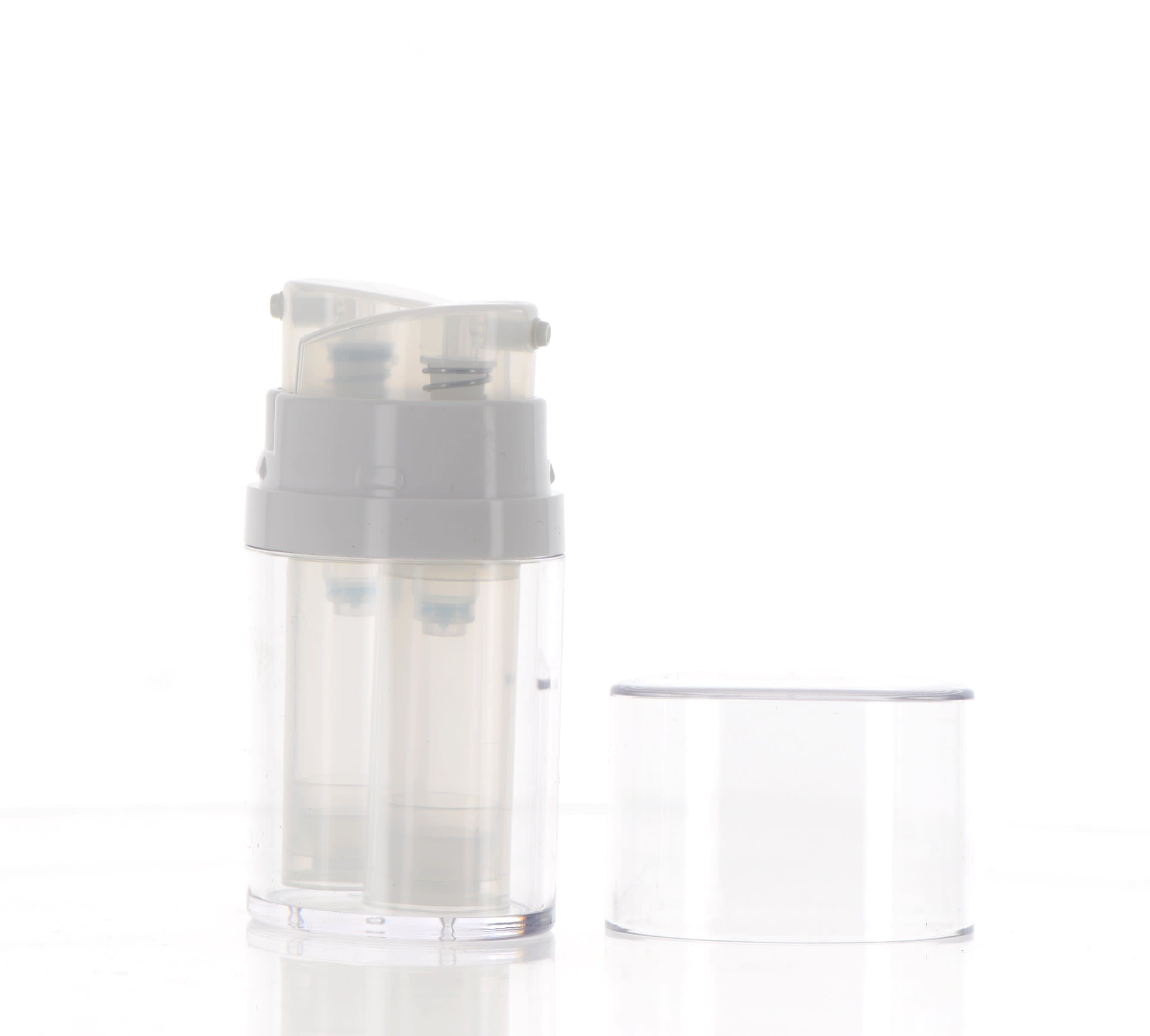 The image shows the APG Packaging 0.3oz Mixed Material Airless Bottle. The bottle features a sleek, cylindrical design with a clear body and a metallic silver-colored pump and cap. The clear body allows for visibility of the product inside, while the pump and cap provide a modern, polished look. The bottle appears to be compact and portable, suitable for travel or on-the-go use.