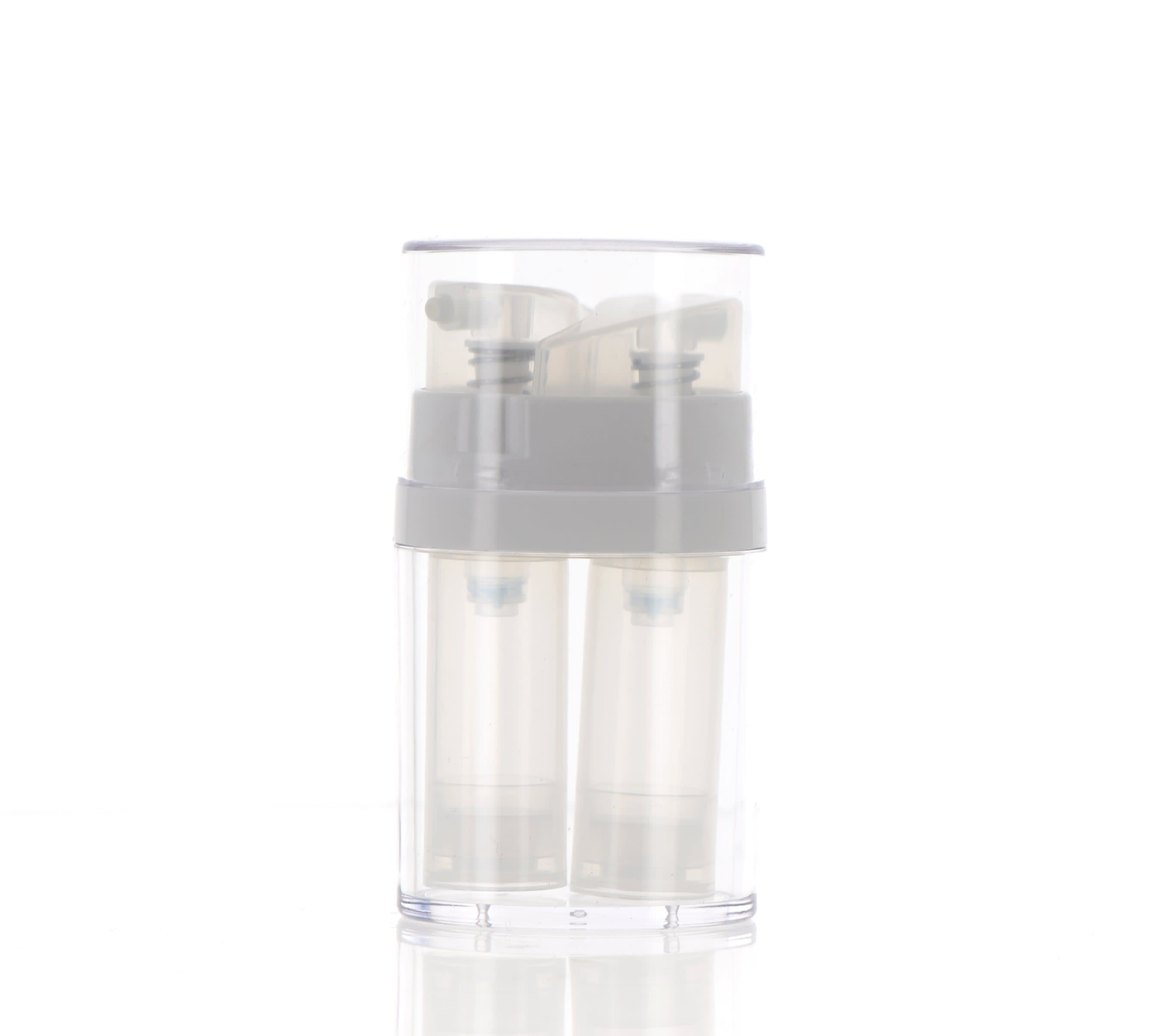 The image shows the APG Packaging 0.3oz Mixed Material Airless Bottle. The bottle features a sleek and minimalist design with a clear cylindrical body and a shiny silver pump dispenser. The cap of the bottle is also silver, matching the pump, and it fits snugly over the dispenser. The clear body of the bottle allows the contents to be visible, emphasizing its clean and modern aesthetic.