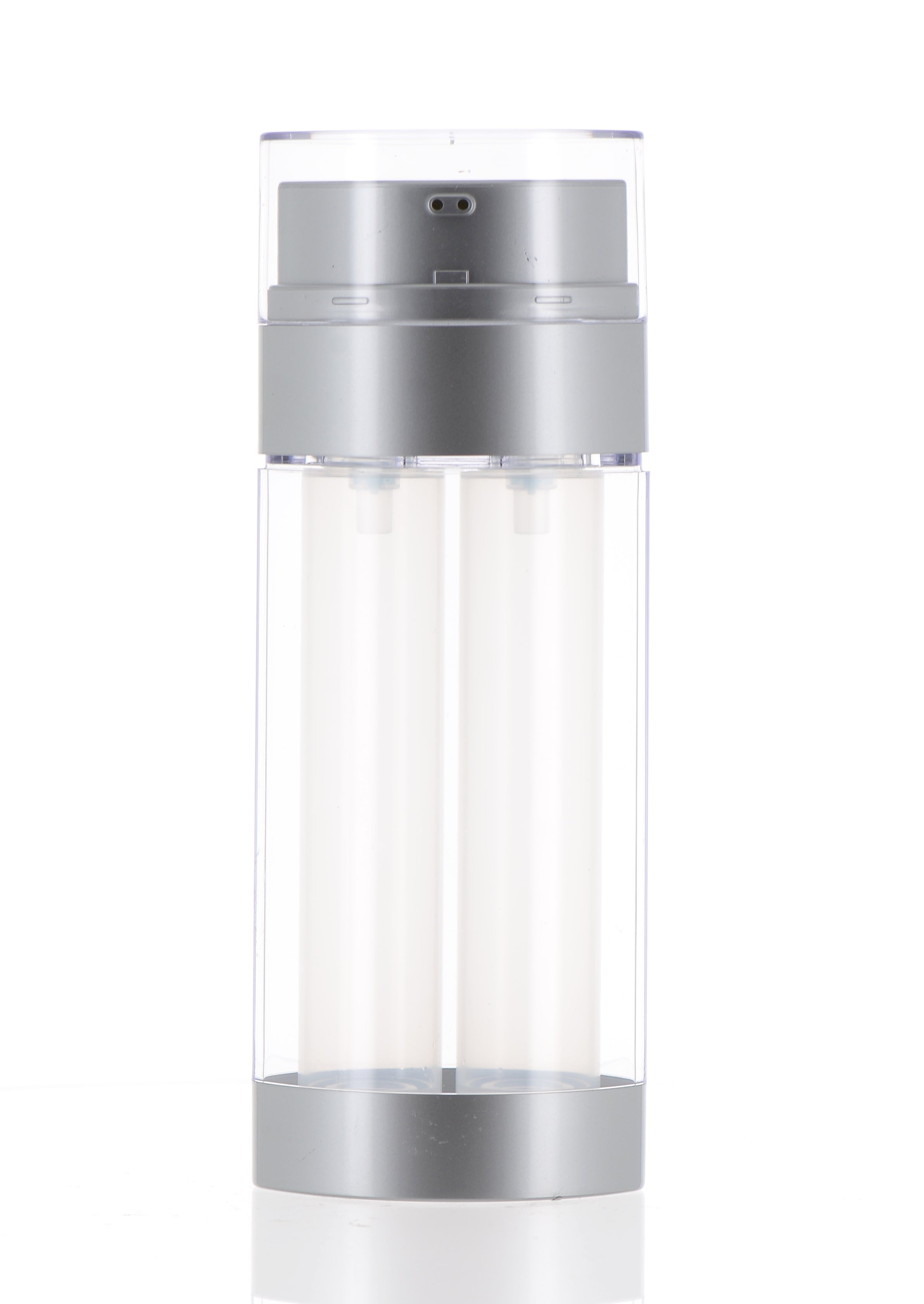 The image shows the APG Packaging 2.0oz PP Airless Bottle (APG-108B60-SV). The bottle is cylindrical with a sleek and modern design. It has a clear body that allows the contents to be visible and a shiny silver cap that fits snugly on top. The airless pump mechanism is visible through the clear body, indicating its functionality for dispensing the product inside without air exposure. The overall appearance is clean and sophisticated, suitable for high-end cosmetic or skincare products.