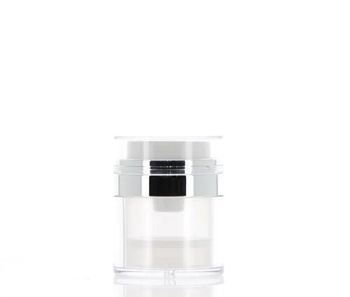 The image shows the APG Packaging 1.0oz Mixed Material Airless Jar. The jar has a sleek, cylindrical design with a clear body and a metallic silver cap. The clear body allows visibility of the product inside, while the silver cap adds an elegant touch. The overall appearance is modern and sophisticated, suitable for high-end cosmetic products.