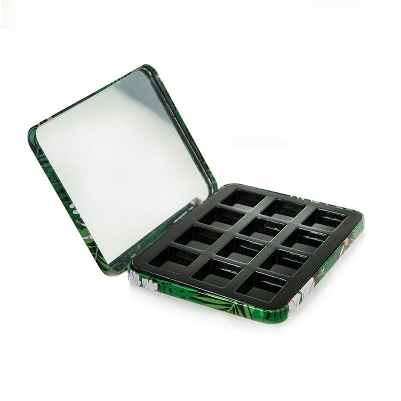 The image shows the APG Packaging 0.0oz Mixed Material Compact (APG-173). It is a sleek, round compact case with a glossy black finish. The compact features a smooth, flat top that appears to be opaque, with a subtle seam where the lid meets the base. The base of the compact is slightly thicker and also has a glossy finish. The compact is closed in the image, and there are no visible logos or text on the exterior. The design is minimalist and elegant, suitable for holding makeup products.
